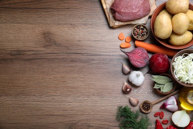 Fresh borscht ingredients on wooden table, flat lay. Space for text