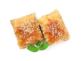 Photo of Eastern sweets. Pieces of tasty baklava with mint isolated on white, top view