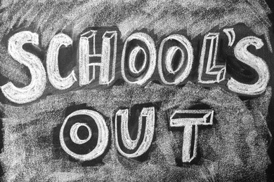 Text School's Out written on black chalkboard. Summer holidays