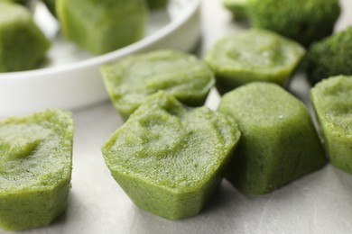 Frozen broccoli puree cubes on table, closeup