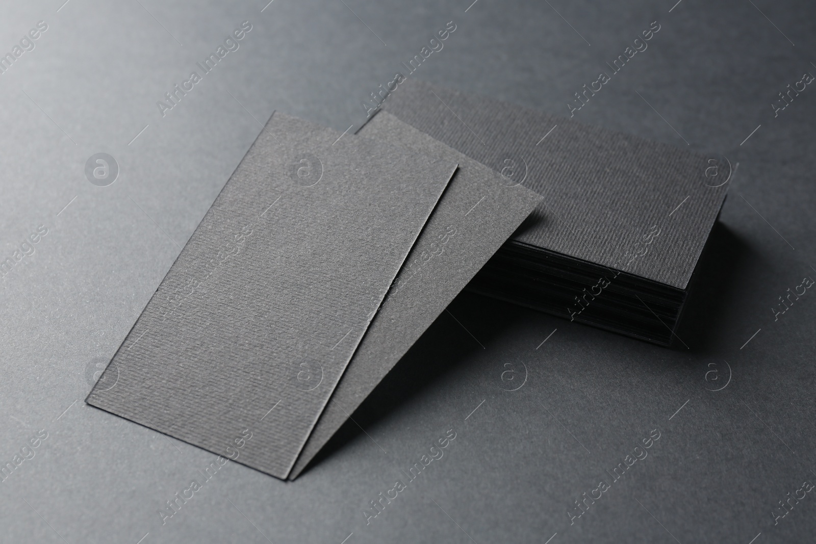 Photo of Blank business cards on black background, closeup. Mockup for design