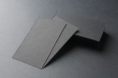 Blank business cards on black background, closeup. Mockup for design