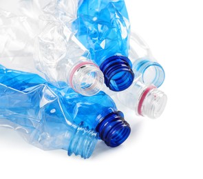 Photo of Crumpled disposable plastic bottles on white background, space for text