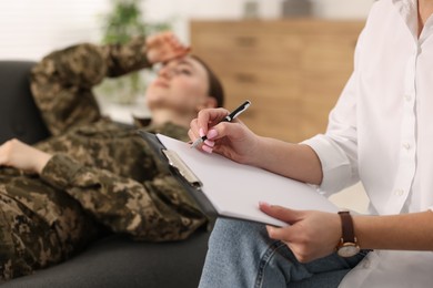 Psychotherapist working with military woman in office