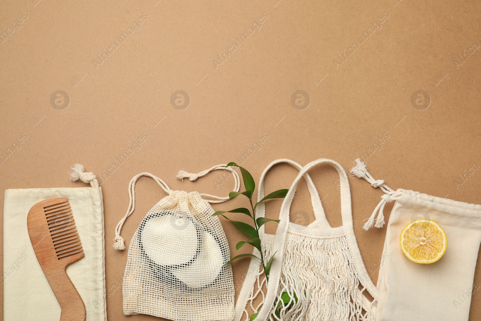 Photo of Eco friendly products on brown background, flat lay. Space for text