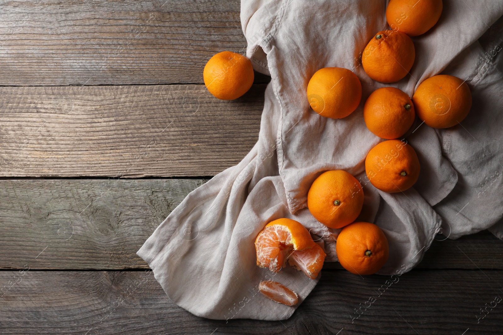 Photo of Tasty fresh tangerines on wooden table, flat lay. Space for text