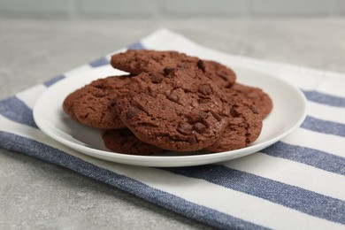 Photo of Delicious chocolate chip cookies on light grey table, closeup