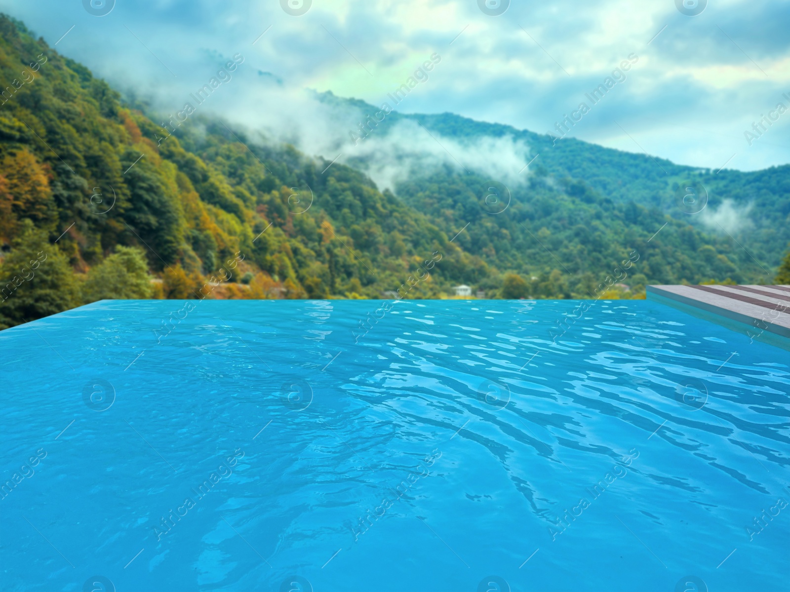 Image of Outdoor swimming pool at luxury resort with beautiful view of mountains