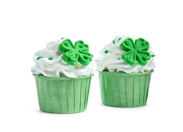 Photo of St. Patrick's day party. Tasty cupcakes with green clover leaf toppers and sprinkles isolated on white