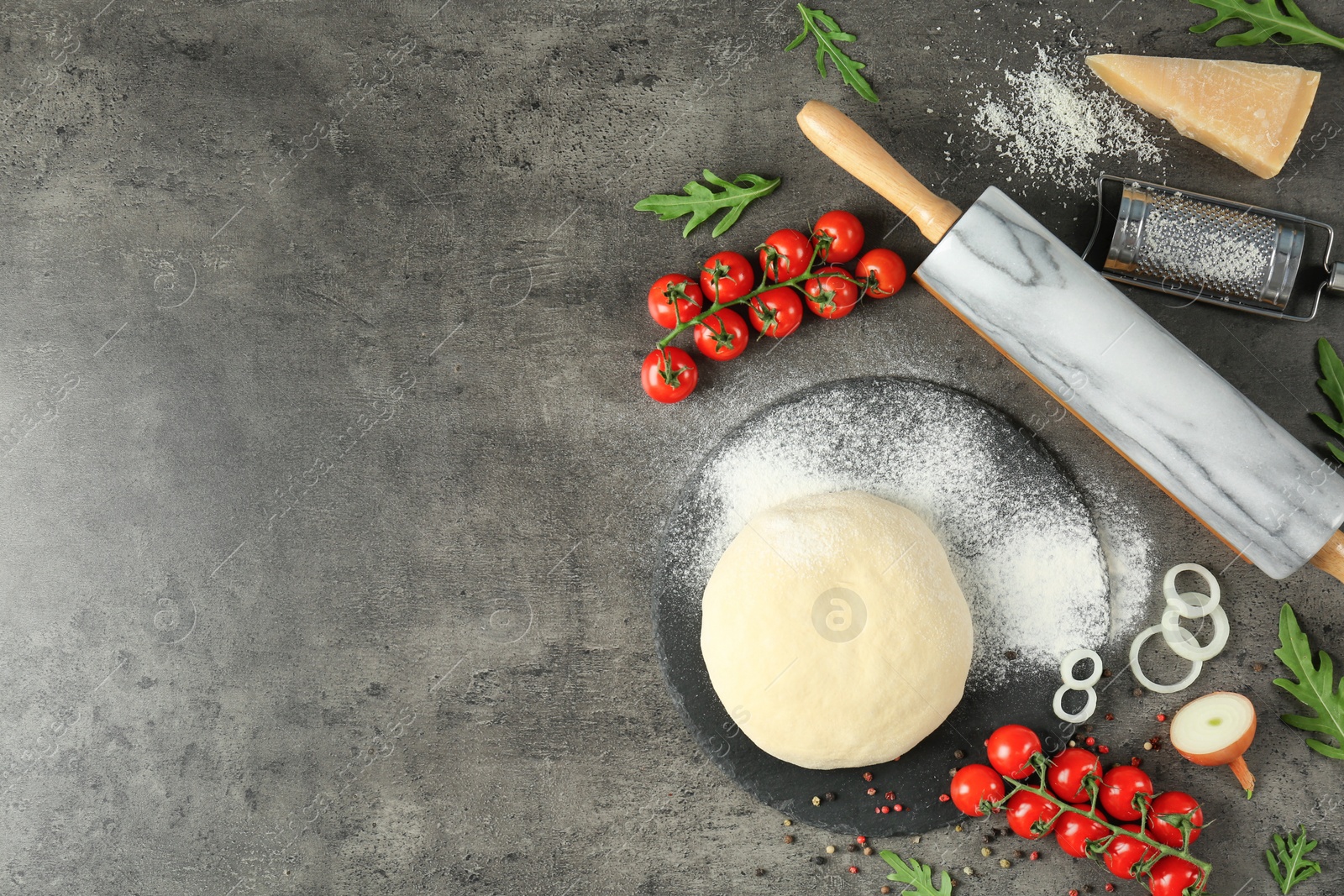 Photo of Dough and ingredients for pizza on table, top view