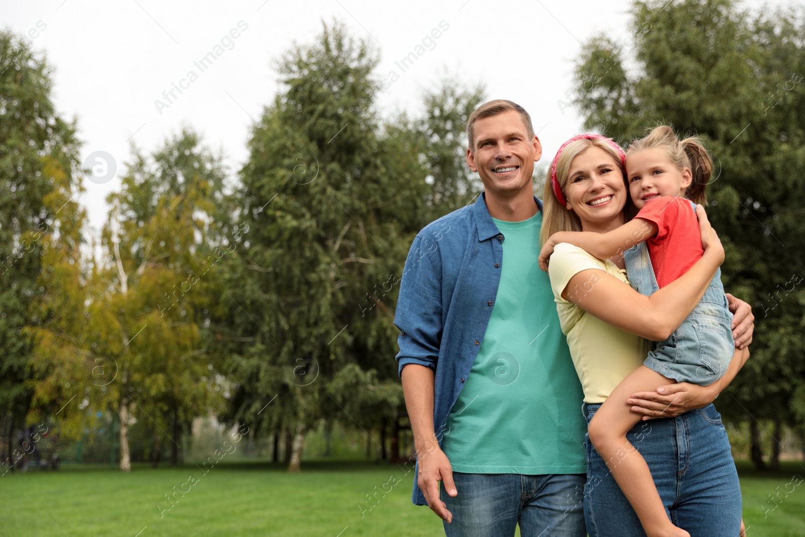 Photo of Happy family spending time together in park on sunny summer day