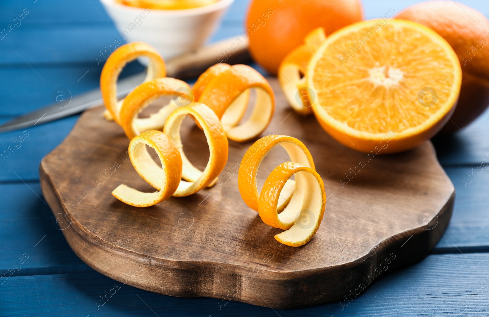 Photo of Orange fruit with peels on blue wooden table