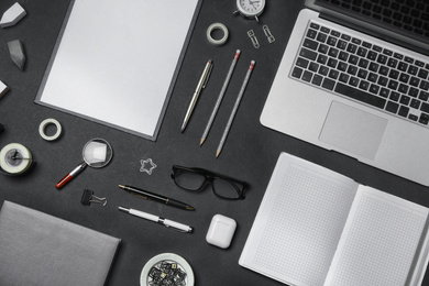 Flat lay composition with laptop and stationery on black background. Designer's workplace