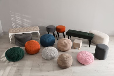 Many stylish different poufs and benches indoors. Home design