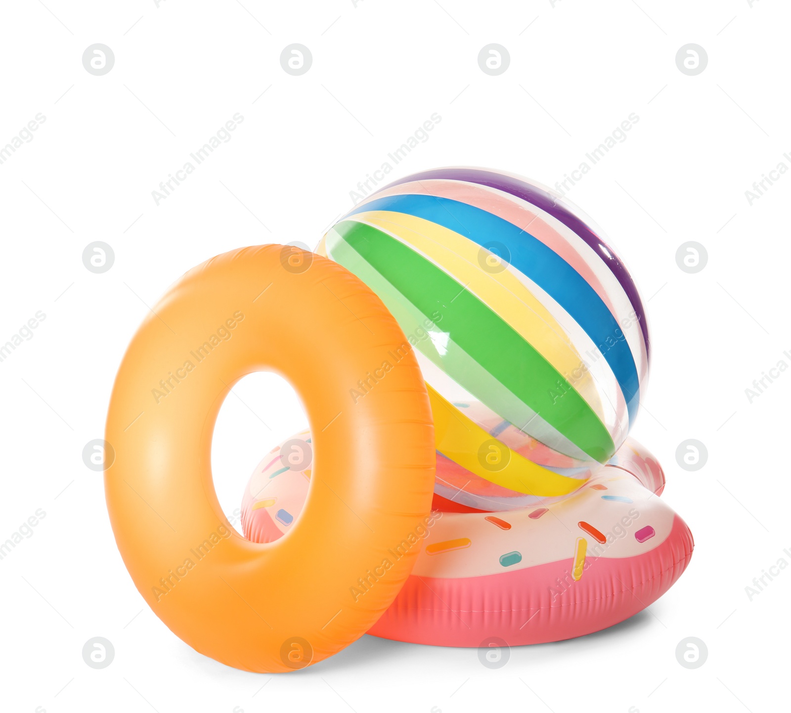 Photo of Bright inflatable rings and ball on white background. Summer holidays