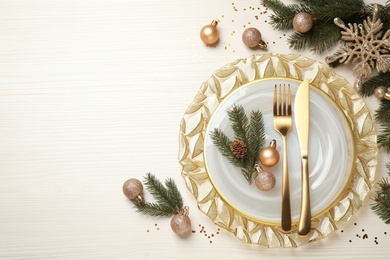 Photo of Beautiful Christmas table setting and festive decor on white wooden background, flat lay. Space for text