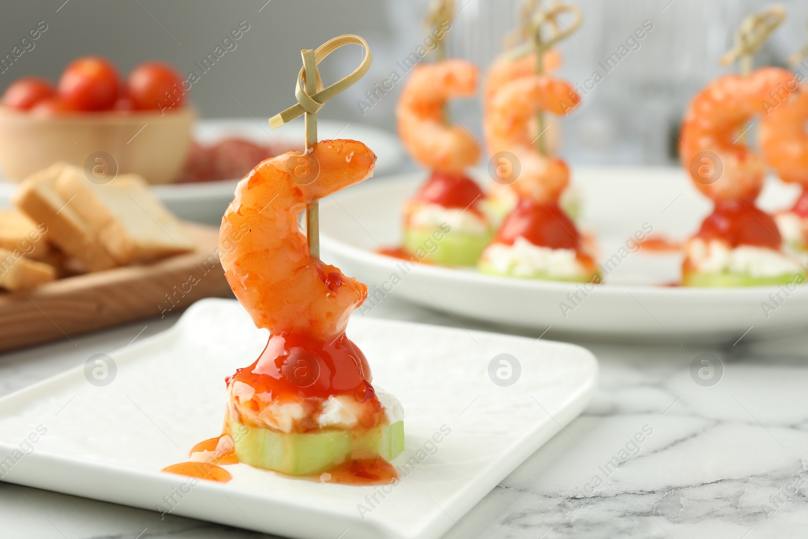 Photo of Tasty canape with shrimp, vegetables and cream cheese on white marble table, space for text