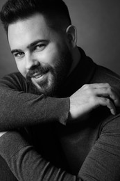 Photo of Portrait of handsome bearded man on dark background. Black and white effect