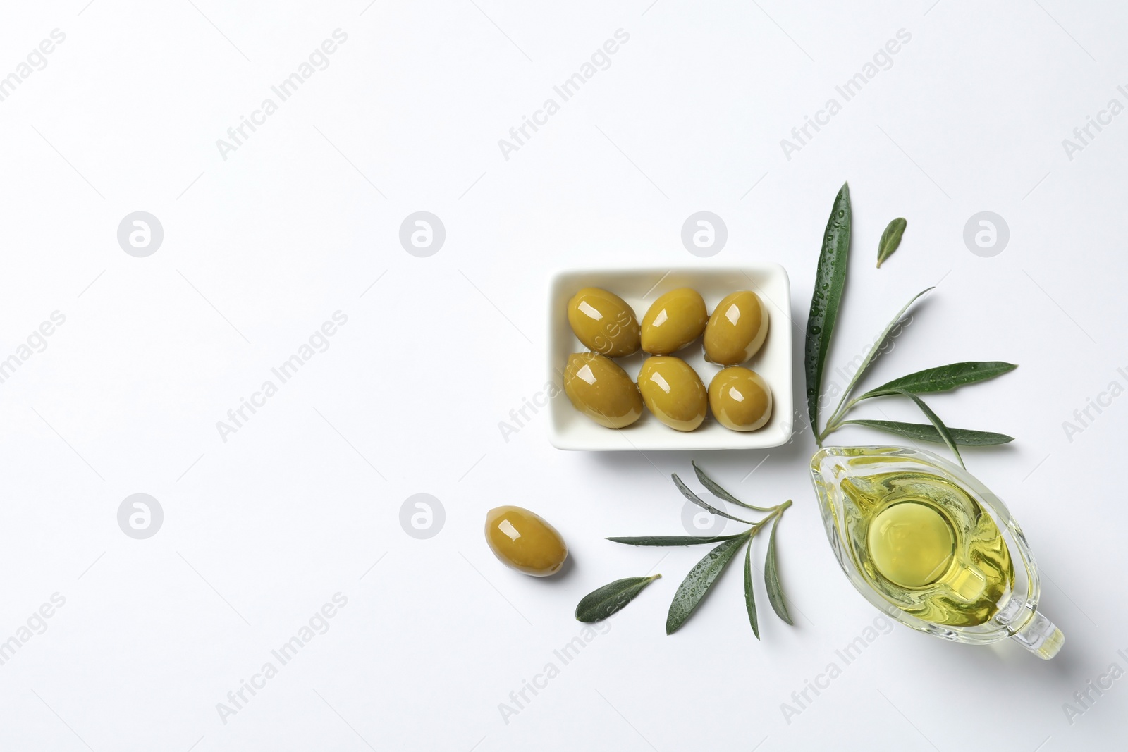 Photo of Beautiful composition with oil and ripe olives on white background