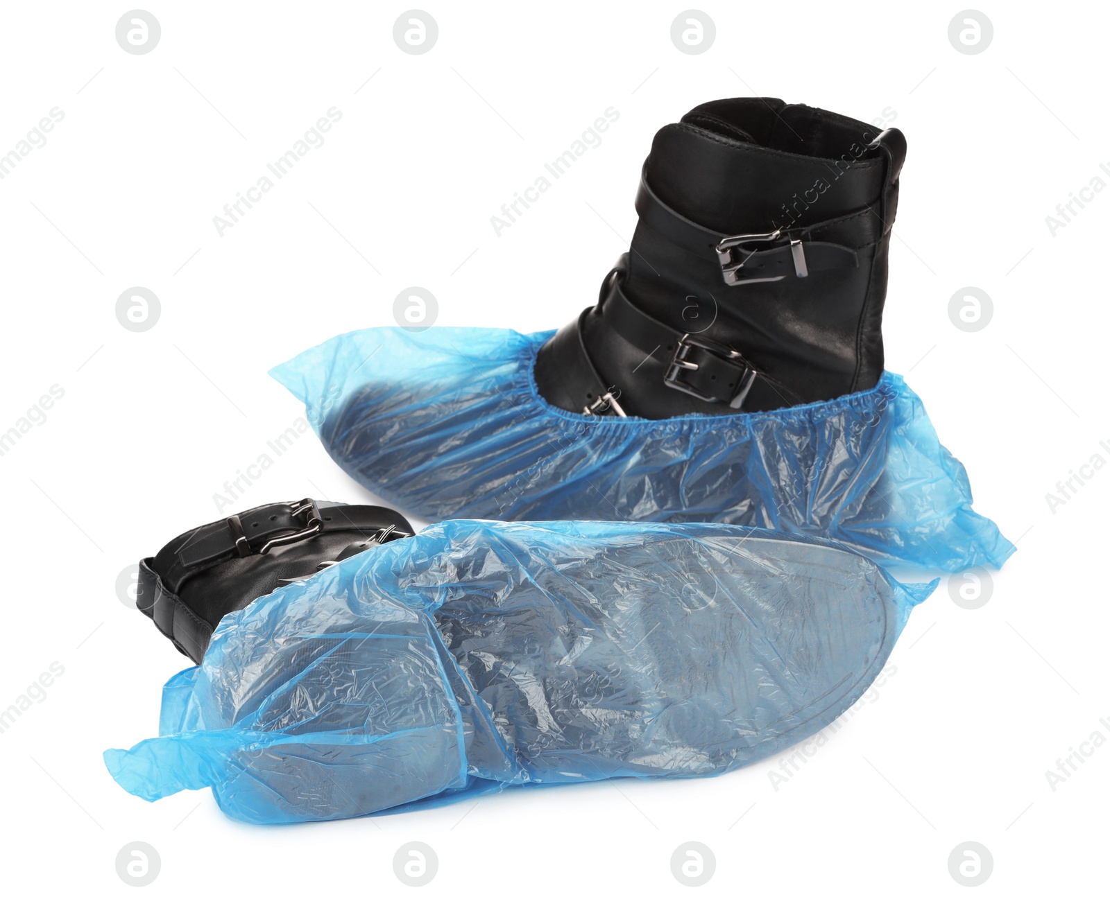 Photo of Women's boots in blue shoe covers isolated on white