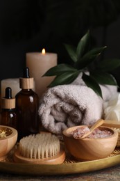 Spa composition. Pink sea salt, brush and bottles on table