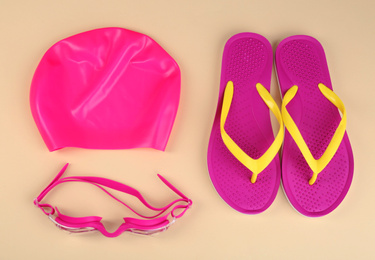 Photo of Flat lay composition with swimming accessories on light background