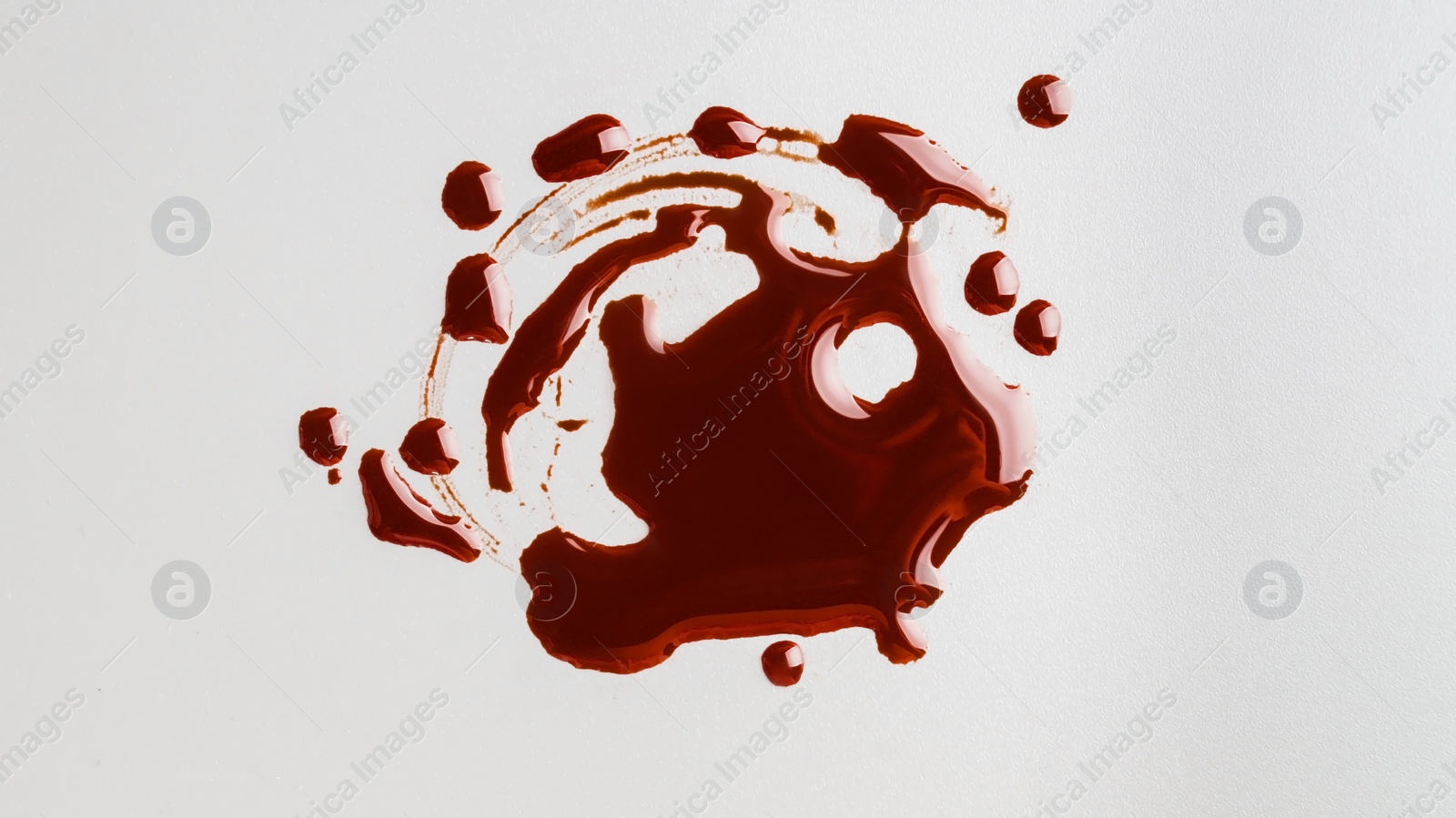 Photo of Stain of blood on grey background, top view