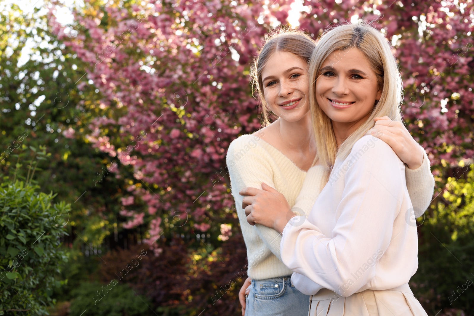 Photo of Happy mother with her daughter spending time together in park on sunny day