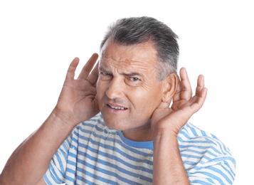 Mature man with hearing problem on white background