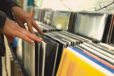 Image of Man choosing vinyl records in store, closeup