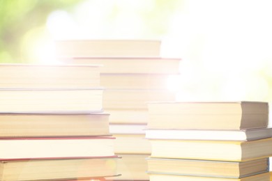 Stacks of books on blurred background. Bokeh effect 