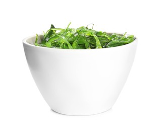 Photo of Japanese seaweed salad in bowl isolated on white