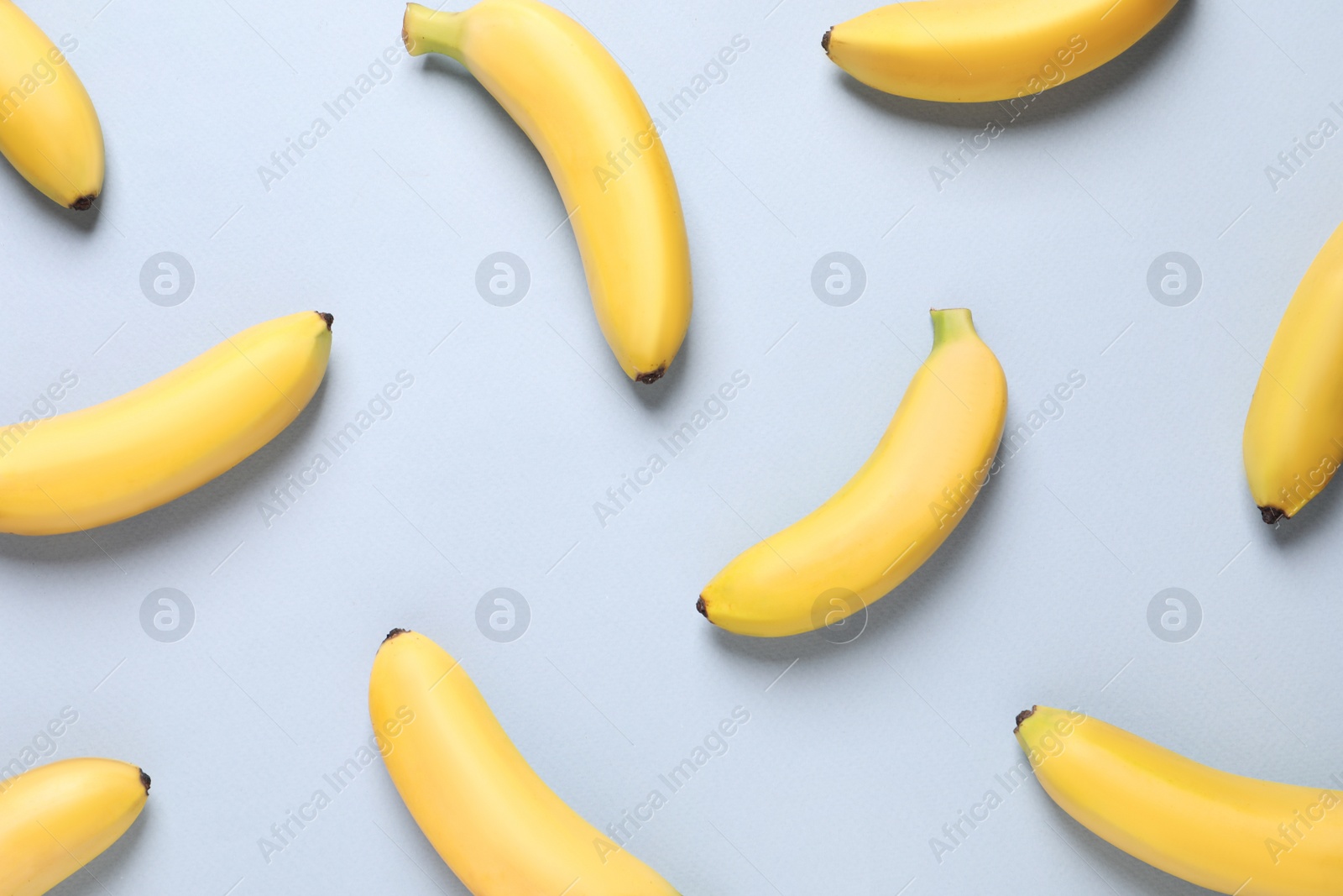 Photo of Sweet ripe baby bananas on light background, flat lay