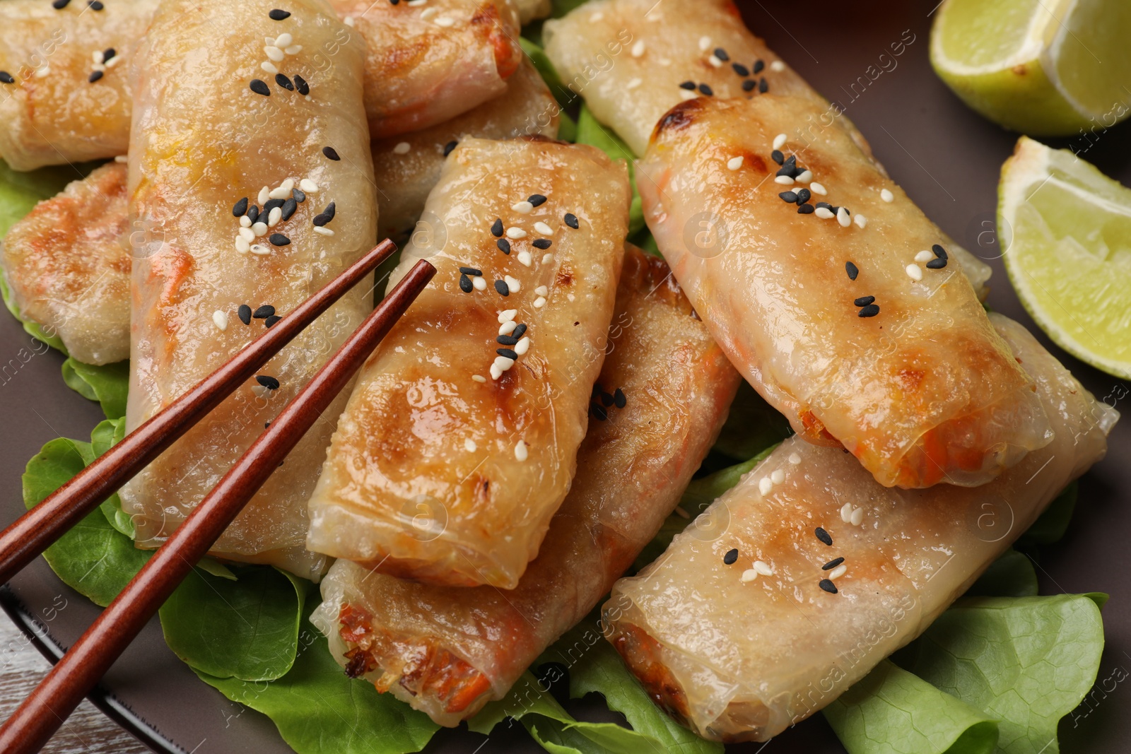 Photo of Tasty fried spring rolls served on table, closeup