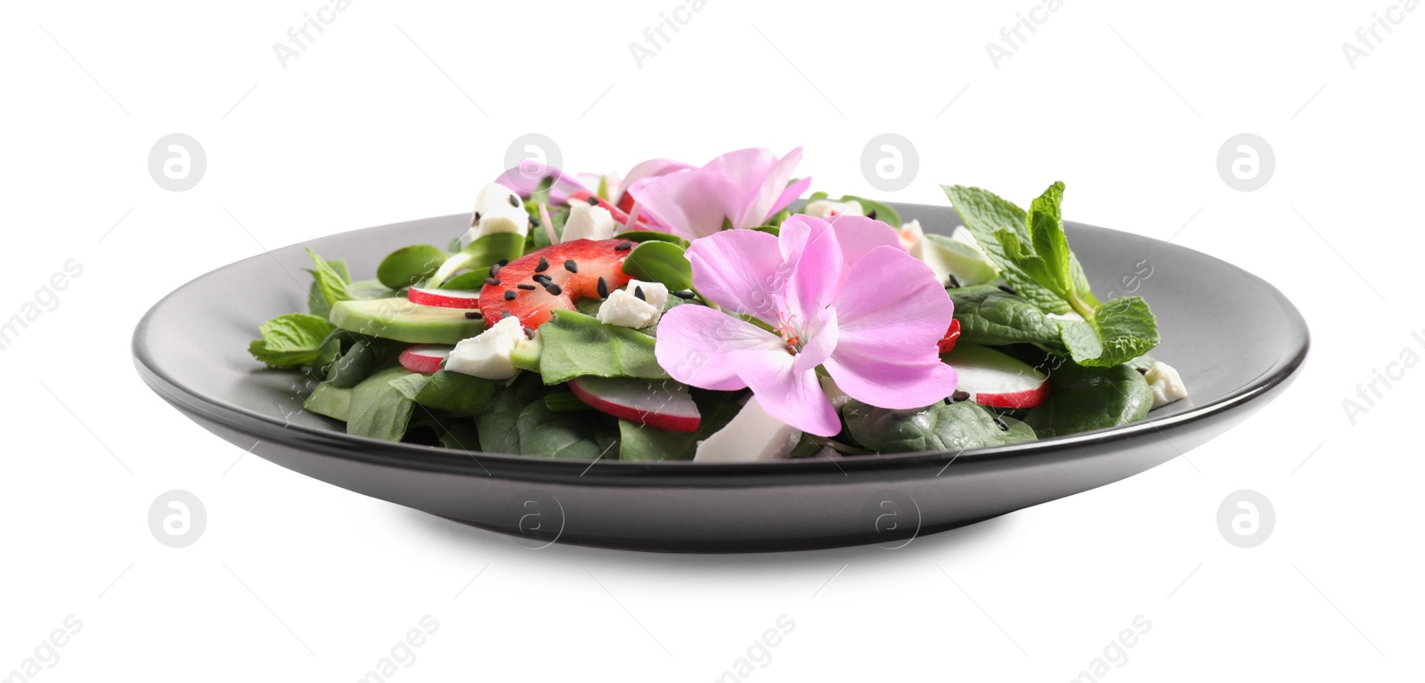 Photo of Fresh spring salad with flowers in plate isolated on white