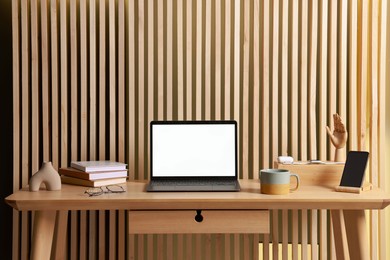 Stylish workplace with laptop and stationery on wooden table indoors