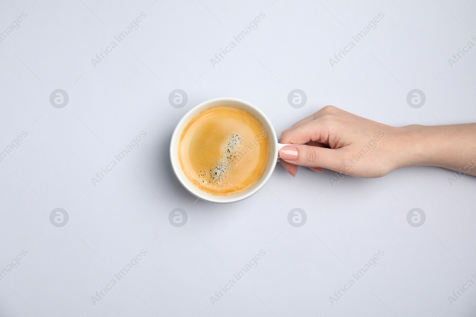 Photo of Woman with cup of coffee on white background, top view