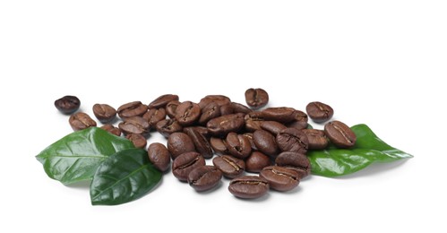 Pile of roasted coffee beans with fresh leaves on white background