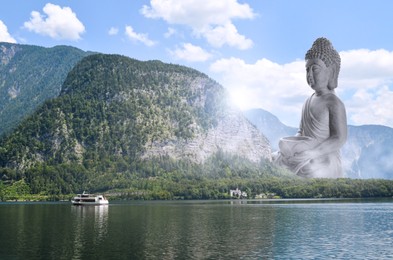 Image of Majestic Buddha sculpture near lake and mountains on sunny day