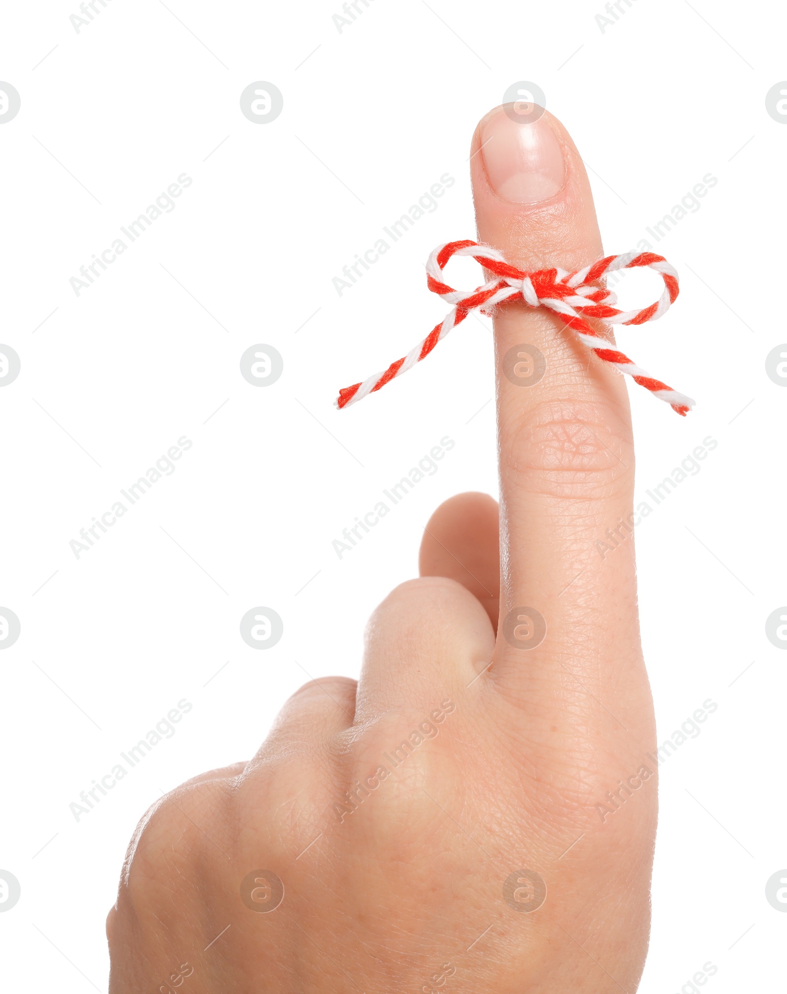 Photo of Woman showing index finger with tied bow as reminder on white background, closeup