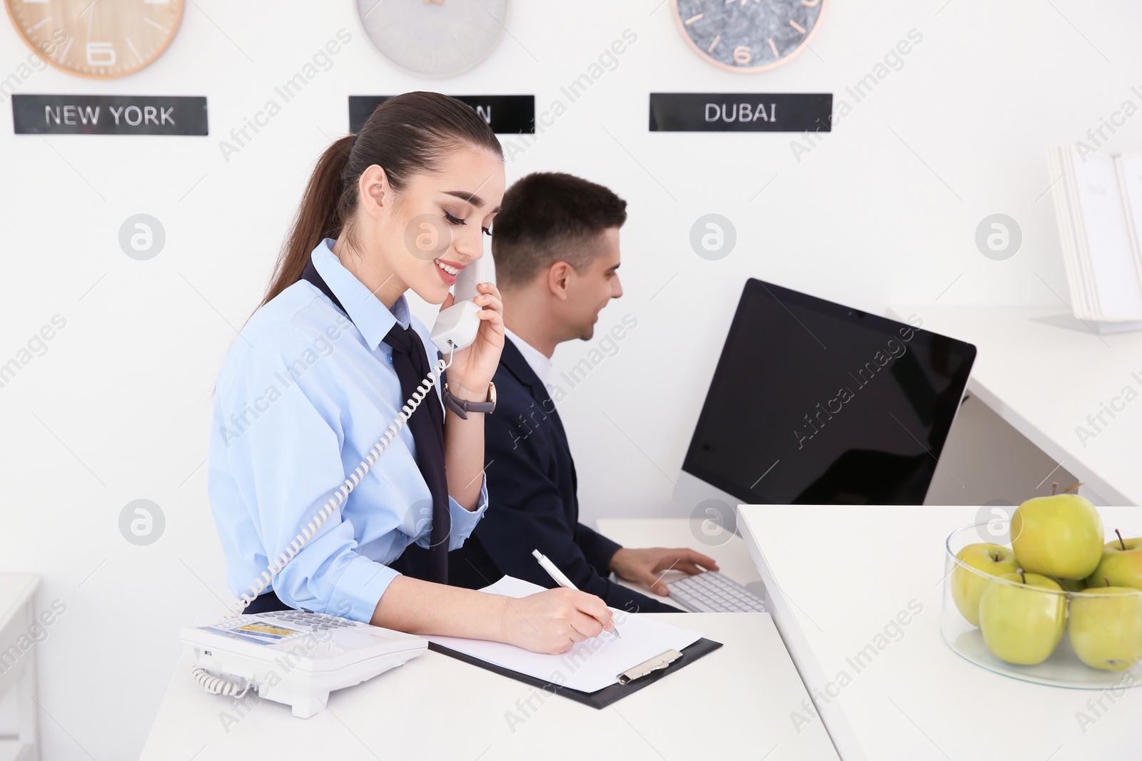 Photo of Busy receptionists at workplace in hotel