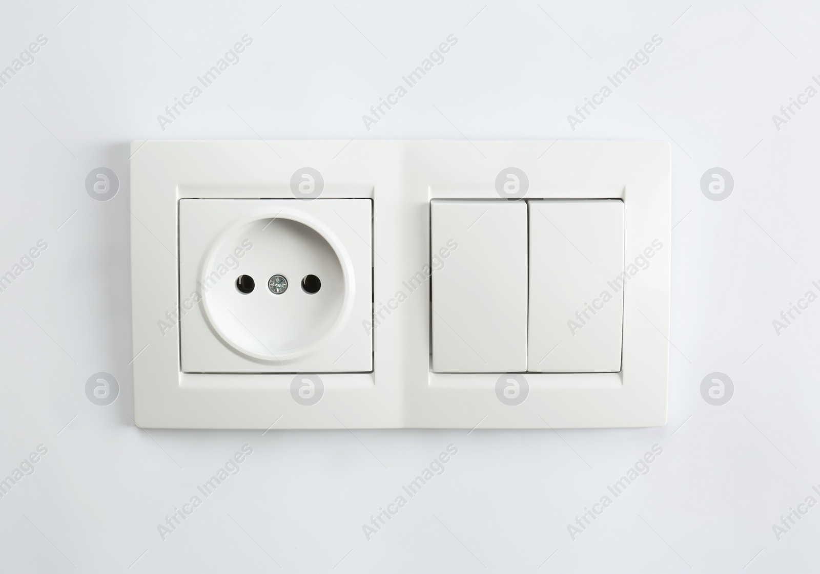 Photo of Light switch and power socket on white background. Electrician's equipment