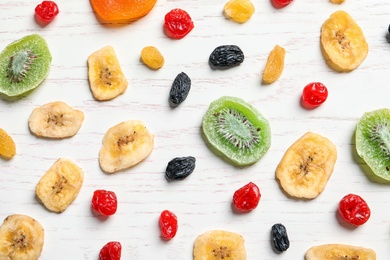 Flat lay composition with different dried fruits on wooden background. Healthy lifestyle