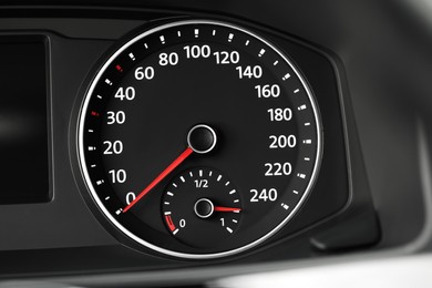 Photo of Speedometer on modern car dashboard, closeup view