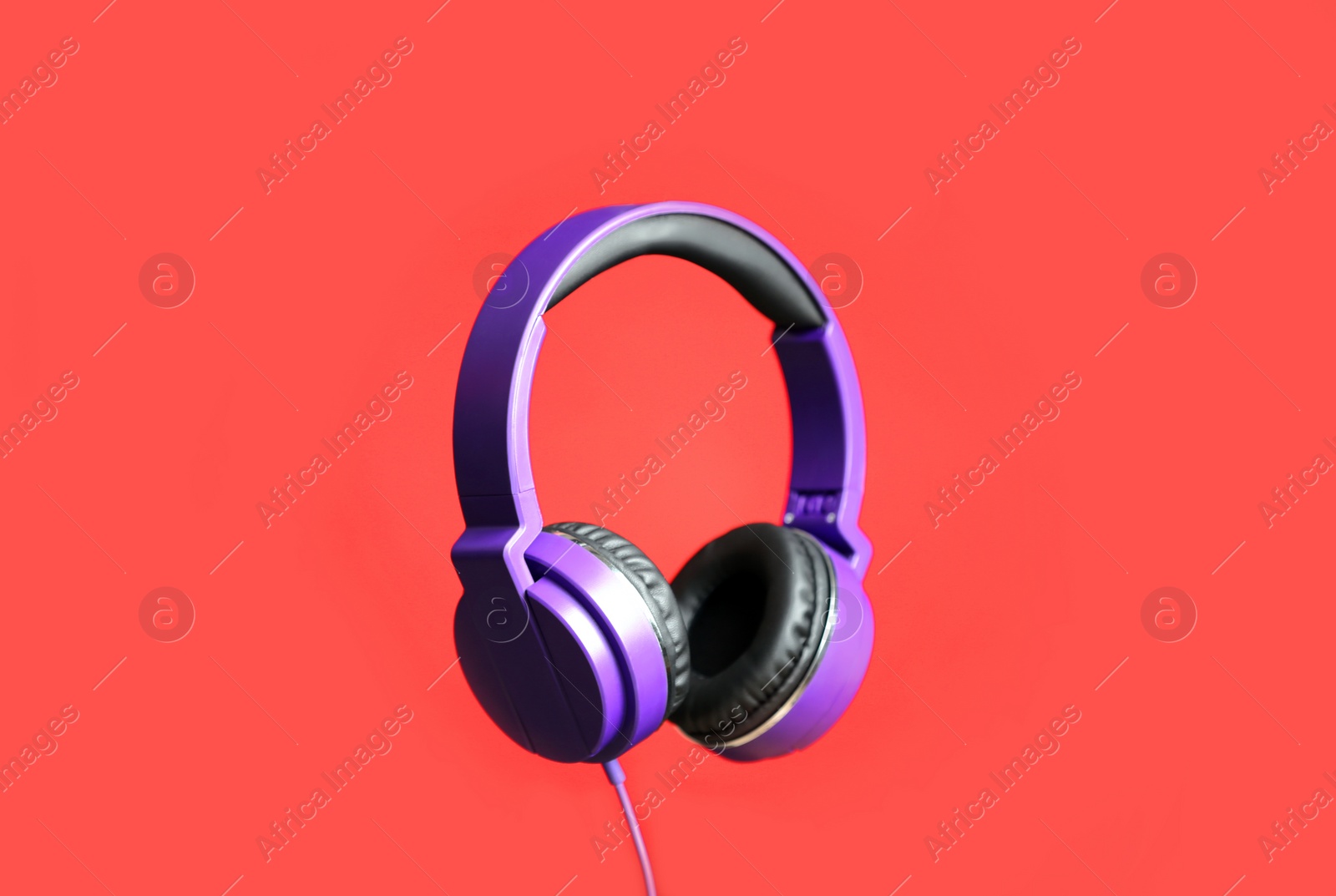 Photo of Stylish headphones with pads on color background