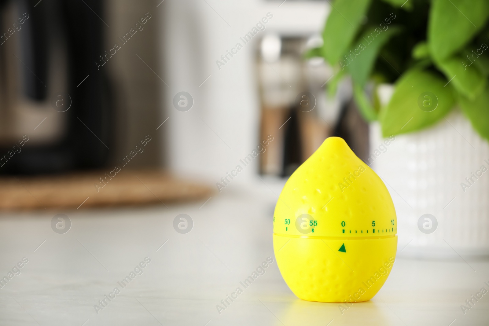 Photo of Kitchen timer in shape of lemon on white table indoors. Space for text