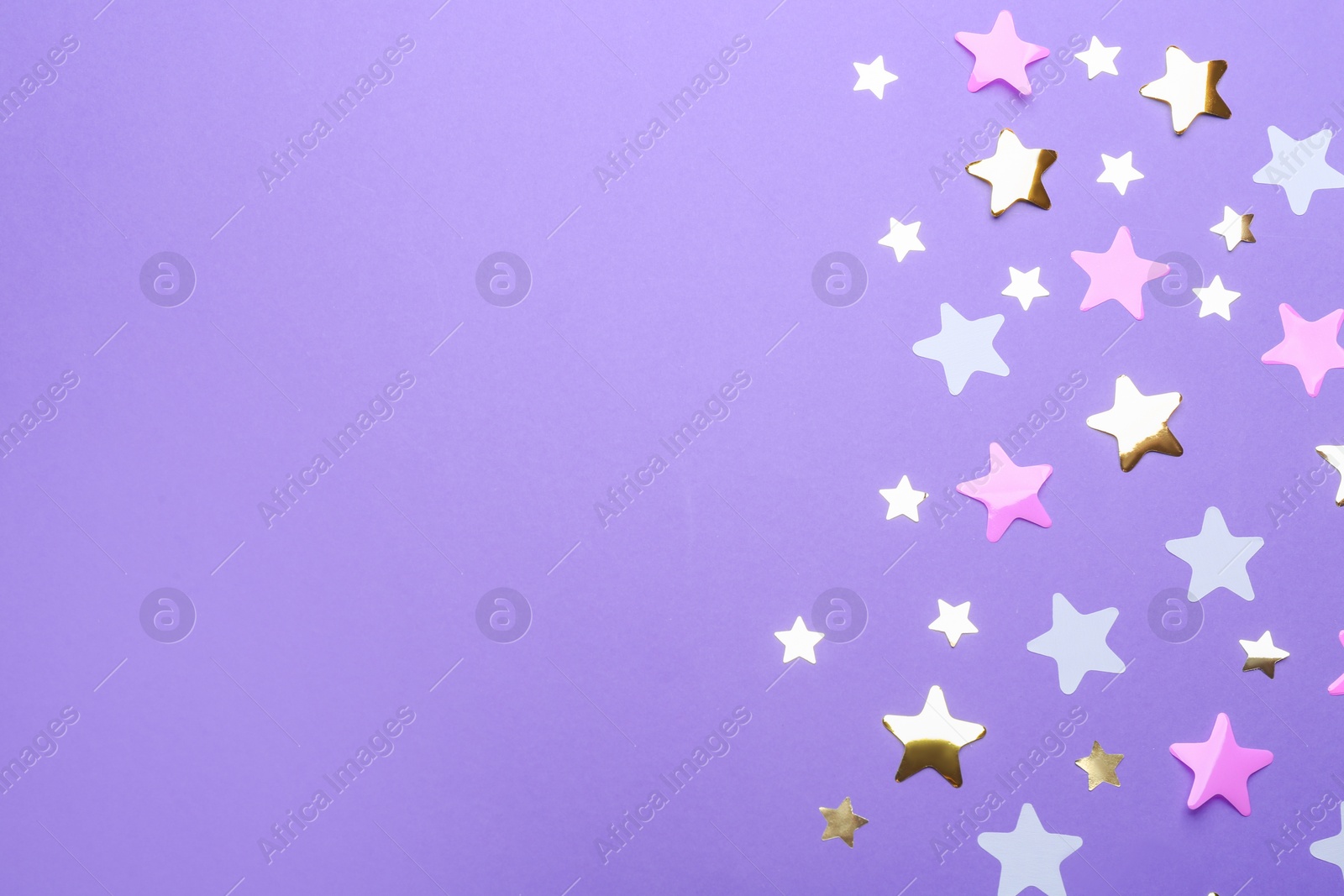 Photo of Confetti stars with space for text on violet background, top view. Christmas celebration