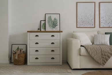 Photo of Modern chest of drawers in living room. Interior design