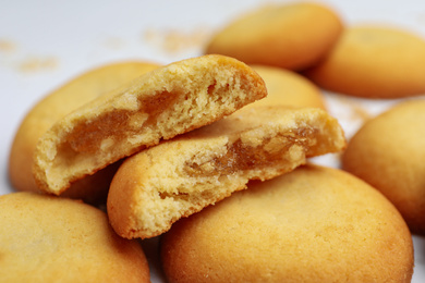 Tasty cookies with filling on white background, closeup