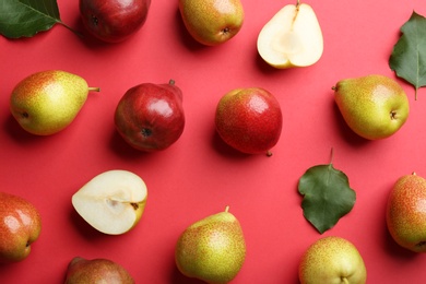 Ripe juicy pears on red background, flat lay